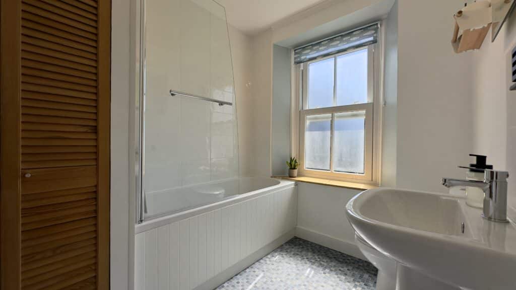 Family bathroom at Crofts Cottage with bath and overhead shower
