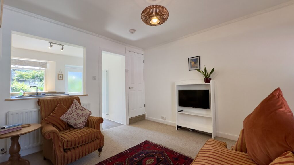 Bright living room at Crofts Cottage in Keswick with television and comfortable seating